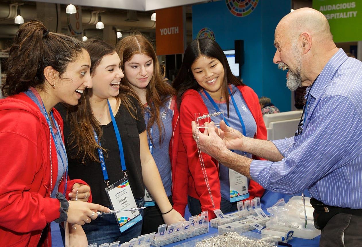 Exhibitor showing his wares to excited participants